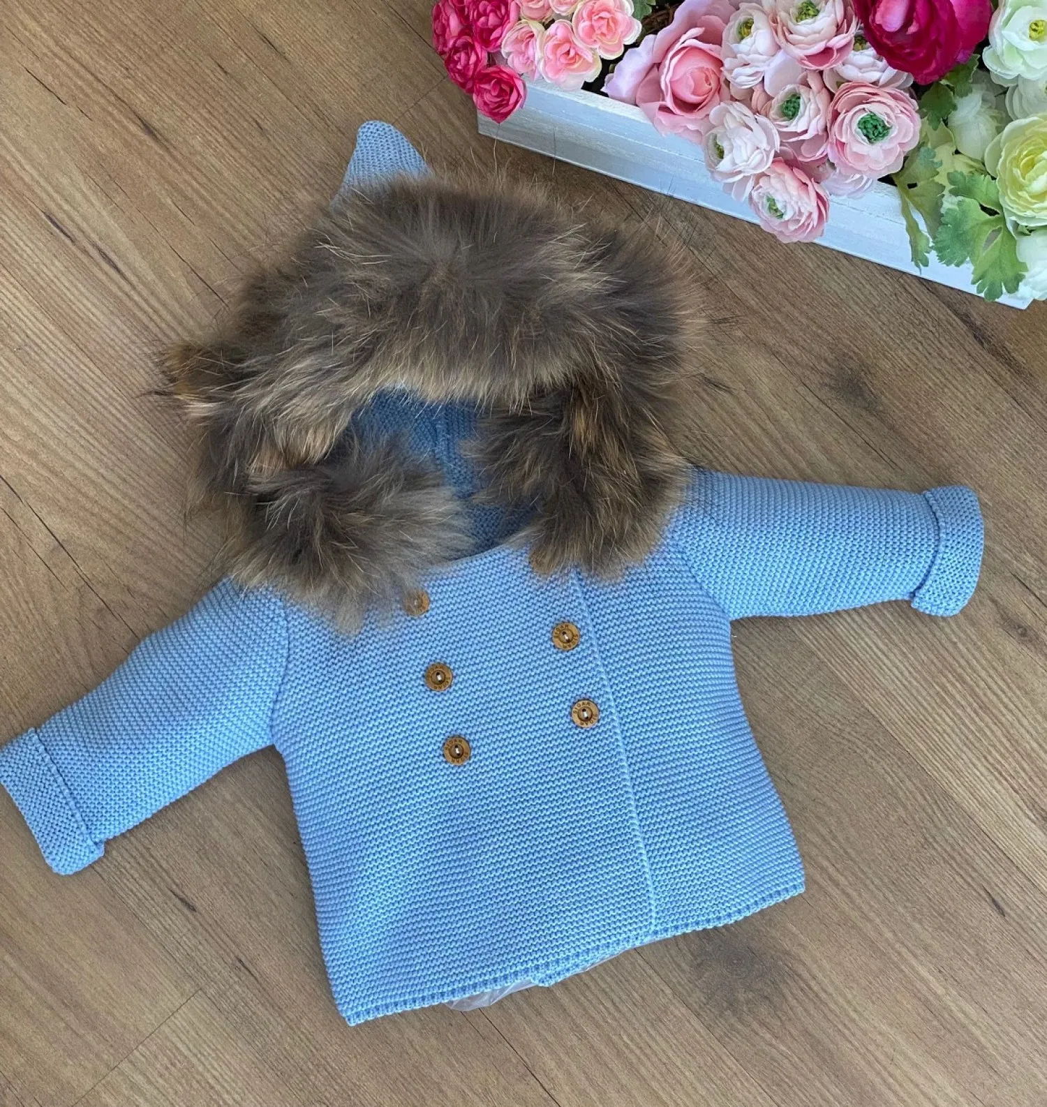 Knitted jacket with a natural fur hood. Various colors